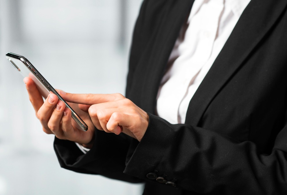 close-up-businesswoman-touching-smartphone-with-finger.jpg