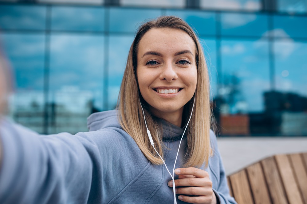 girl-earphones-taking-selfie-outdoors.jpg