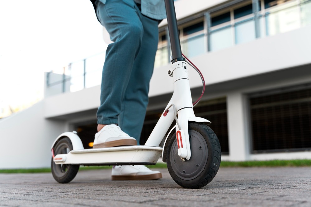 man-riding-scooter-outside.jpg