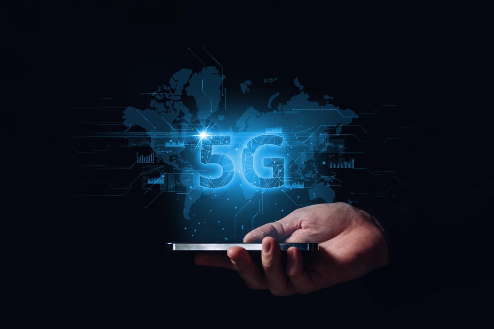 technology-international-modern-networks-5g-background-world-map-hologram-smartphone-hands-person.jpg