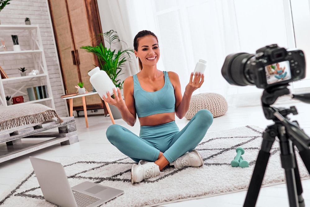 woman-blogger-floor-with-dumbbells-laptop-showing-jar-sports-nutrition-proteins.jpg